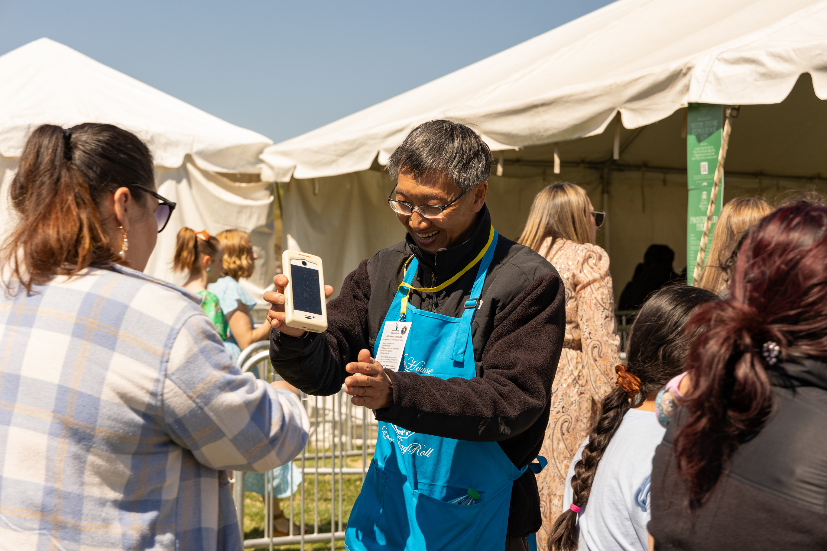 A volunteer scans visitors tickets at an event