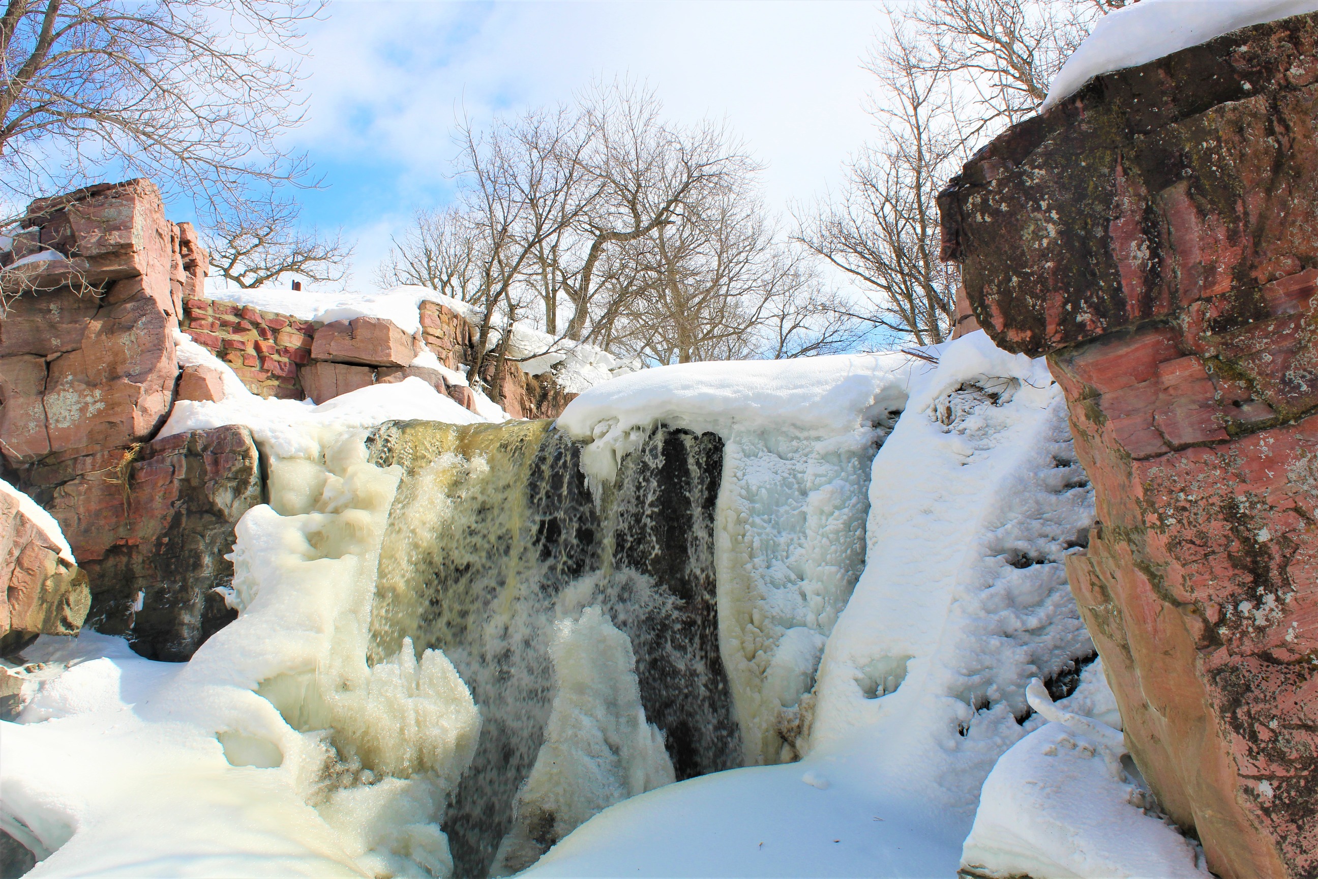 Partially iced-over waterfall as it begins to thaw
