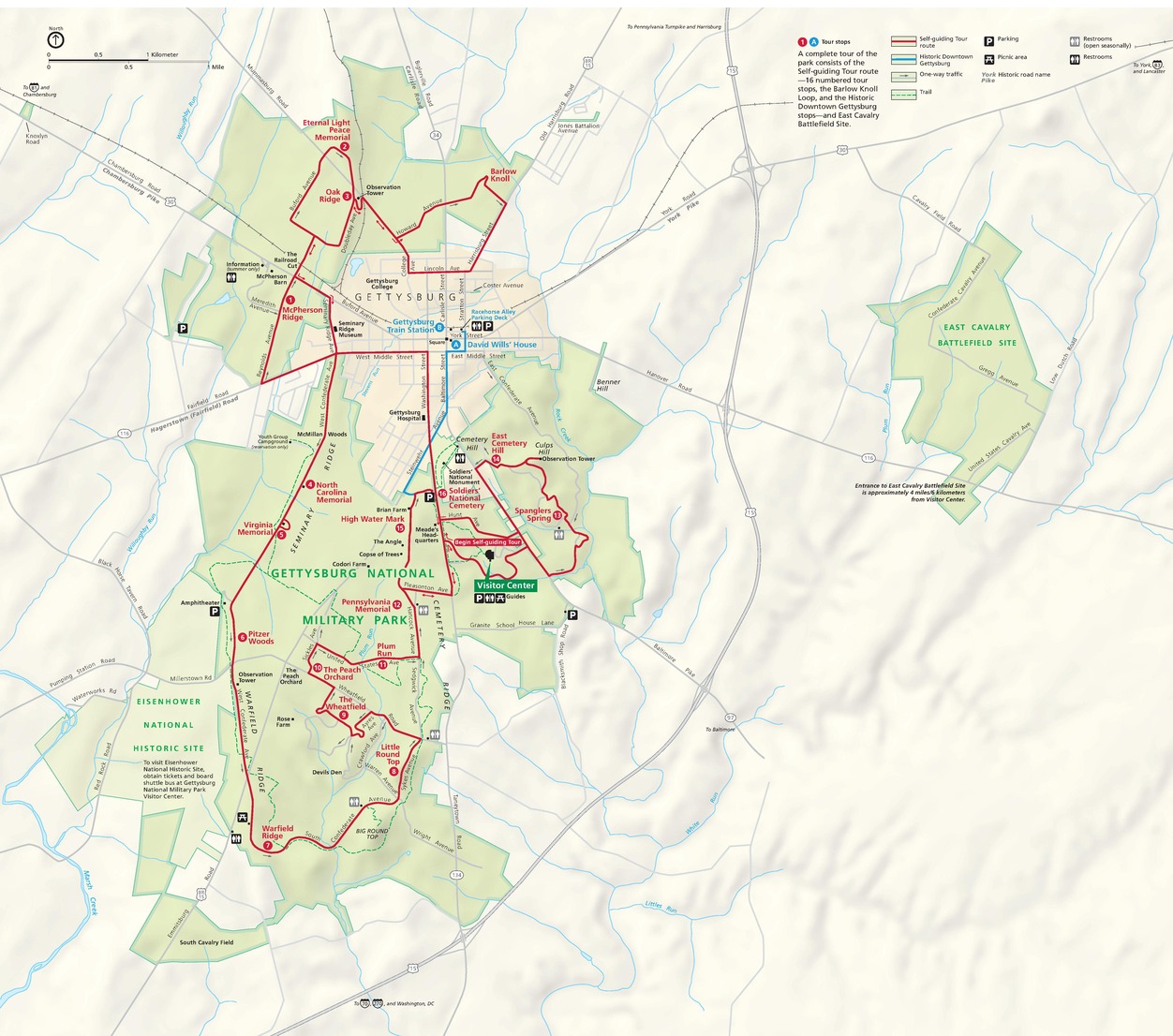 Map of Gettysburg National Military Park in Pennsylvania. The park is highlighted in green with the surrounding area in tan. A solid red line weaving through the park represents a self-guided tour route.