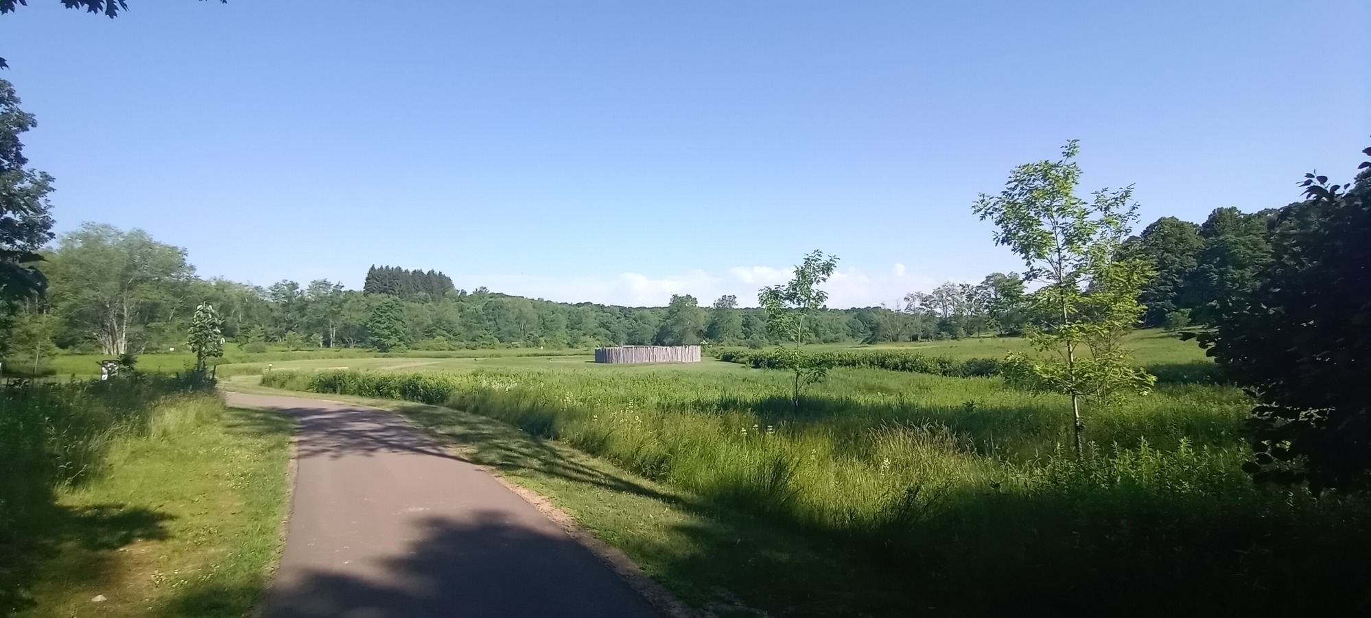 A wide open grassy area with a path leading to Fort Necessity