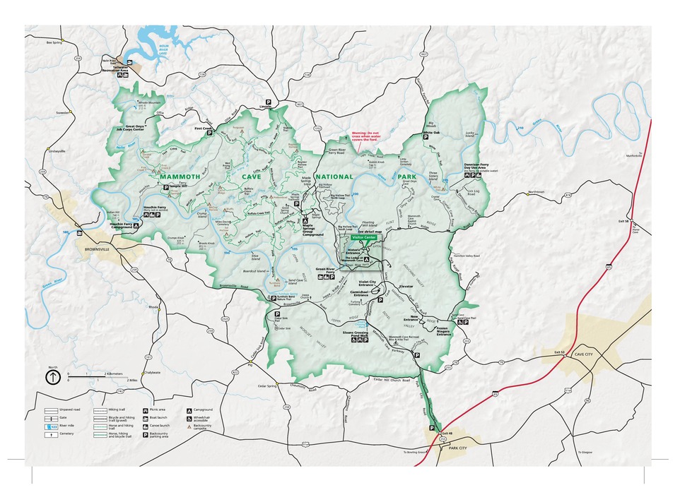 Map of Mammoth Cave National Park in Kentucky. The park area is shown in green, surrounding terrain in ivory white, roads mostly in black, and a few towns in yellow.