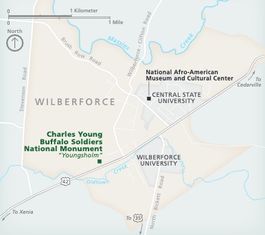 Map of Charles Young Buffalo Soldiers National Monument (NM) in Wilberforce, Ohio. The long edge of the trapezoidal-shaped town is angled to the northeast. The town is shown in beige, surrounding areas in blue, and the park represented with a green square.
