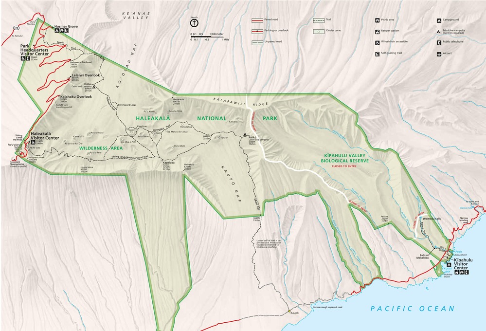 Map of Haleakalā National Park in Hawaii. The park is outlined and highlighted in green with the surrounding area in tan. The park has multiple arms that extend from the main park area towards the Pacific Ocean on the bottom right to just past Koʻolau Gap on the left. Dashed lines represent trails, and red lines are for roads.