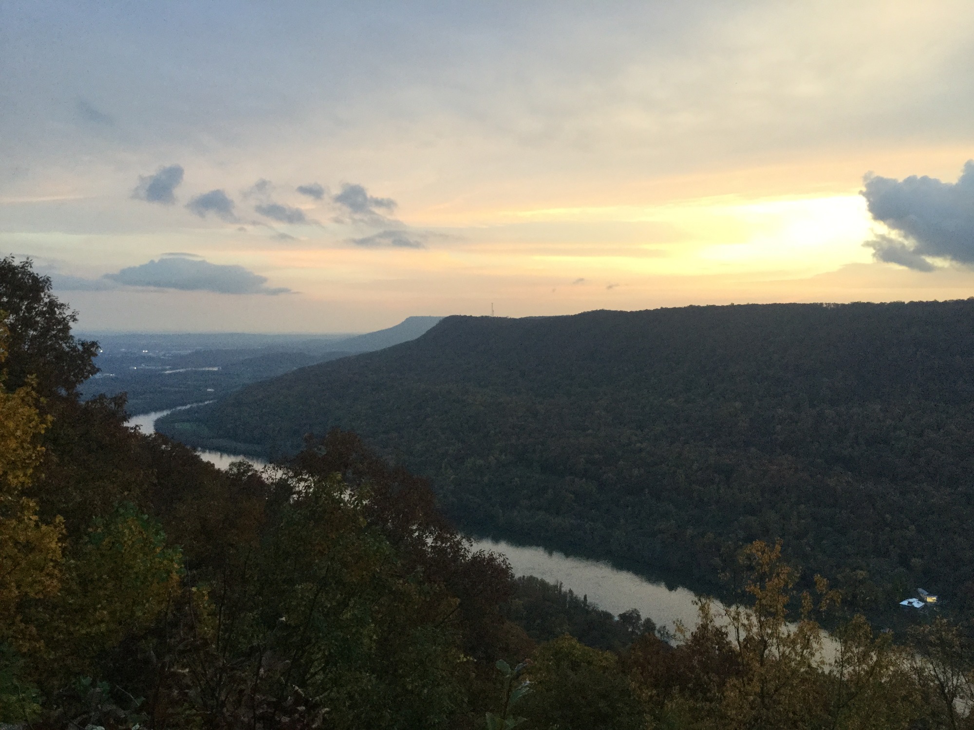 A long ridge alongside a river at sunset