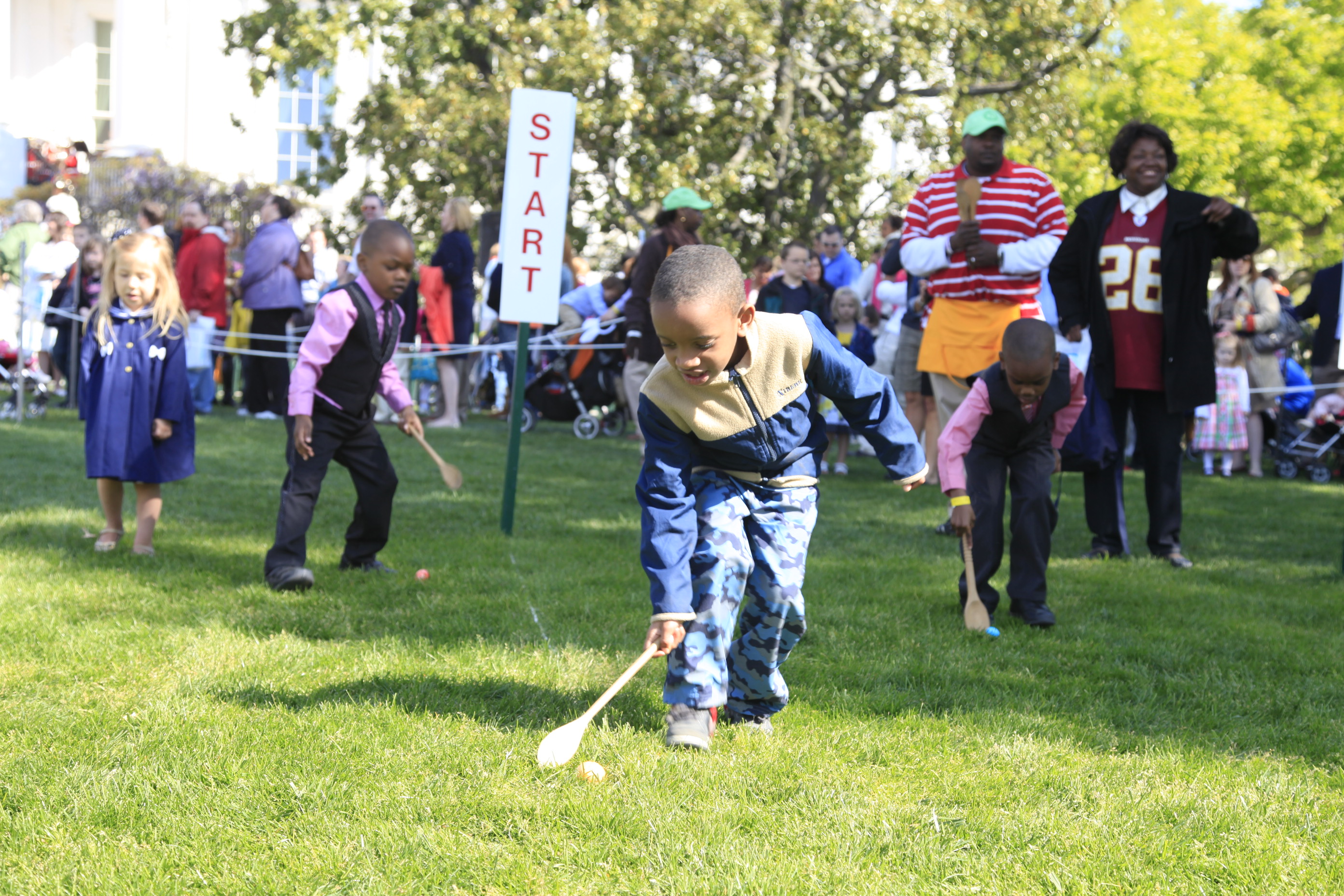 A young boy participates in the egg roll. 