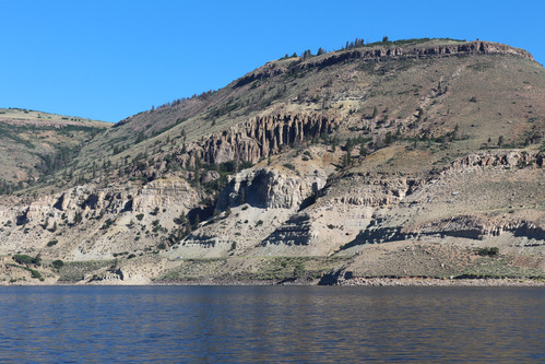 Pinnacle formations on a tall mesa with flatwater in the foreground