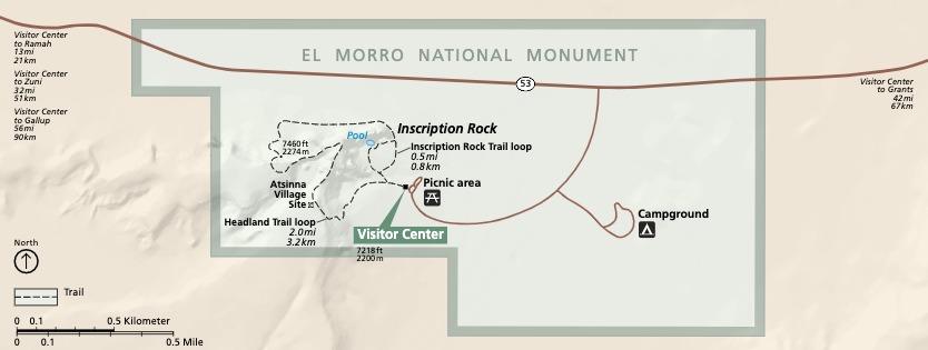 Park map of El Morro National Monument in New Mexico. The park is outlined in green and filled in with a paler shade. The surrounding areas are beige and roads are dark brown.