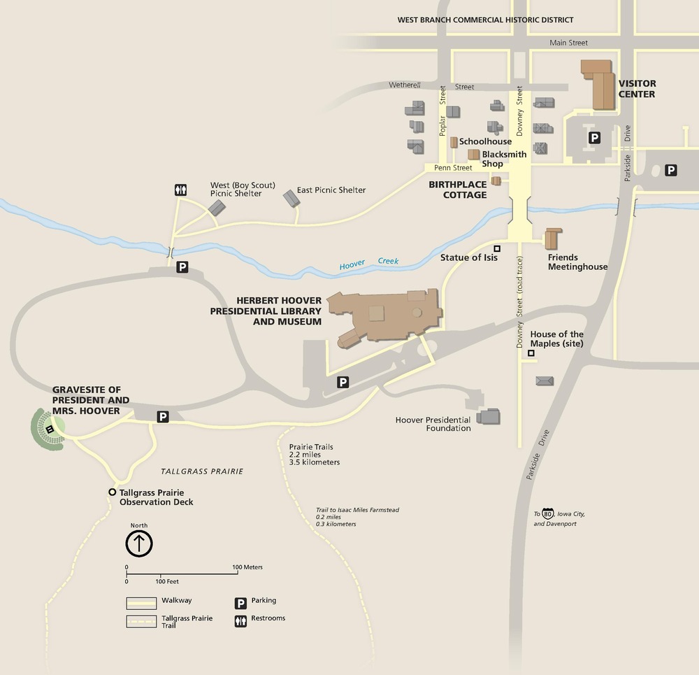 Map of Herbert Hoover National Historic Site in Iowa. All shown in perspective, some buildings are brown and others gray. Some gray streets and pathways are lined or filled in with yellow, and the Hoover Creek winds across the middle of tan map.