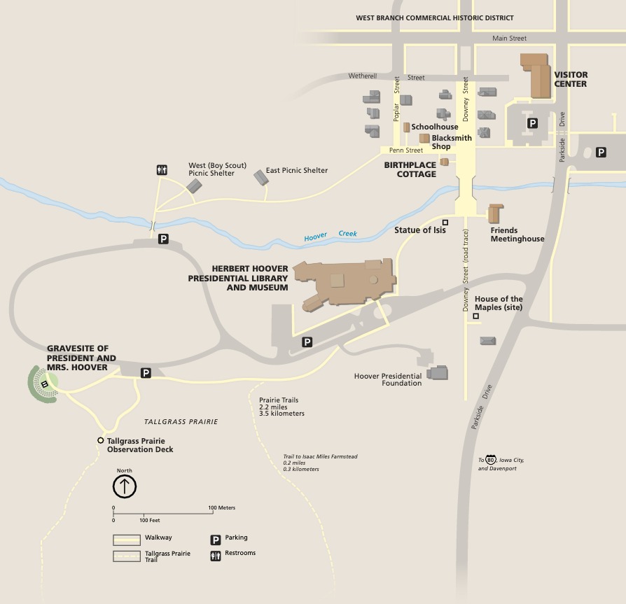 Map of Herbert Hoover National Historic Site in Iowa. All shown in perspective, some buildings are brown and others gray. Some gray streets and pathways are lined or filled in with yellow, and the Hoover Creek winds across the middle of tan map.