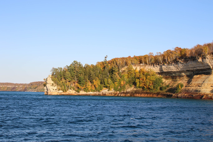 Tall, forested cliff faces jutted out into a large lake