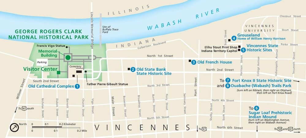 Map of George Rogers Clark National Historical Park in Indiana. The park is shown in green within a grid of white streets creating tan city blocks. The Wabash River curves across the top of the map, and eight locations are numbered and identified in blue text.