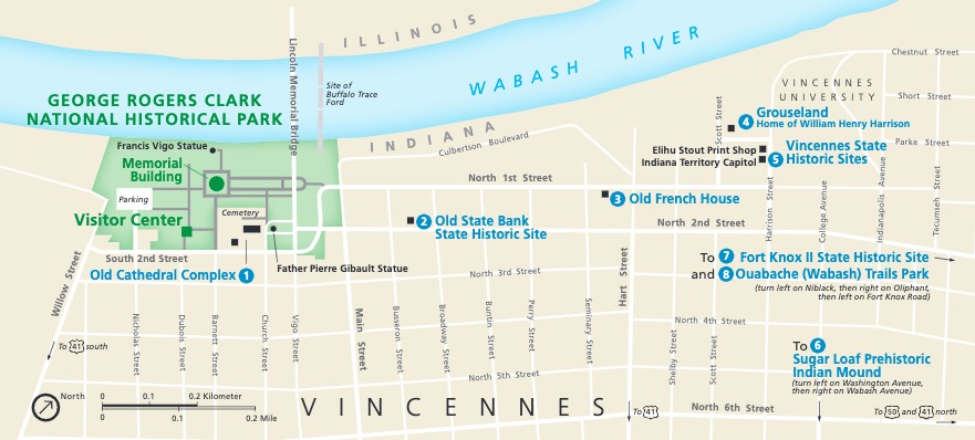 Map of George Rogers Clark National Historical Park in Indiana. The park is shown in green within a grid of white streets creating tan city blocks. The Wabash River curves across the top of the map, and eight locations are numbered and identified in blue text.
