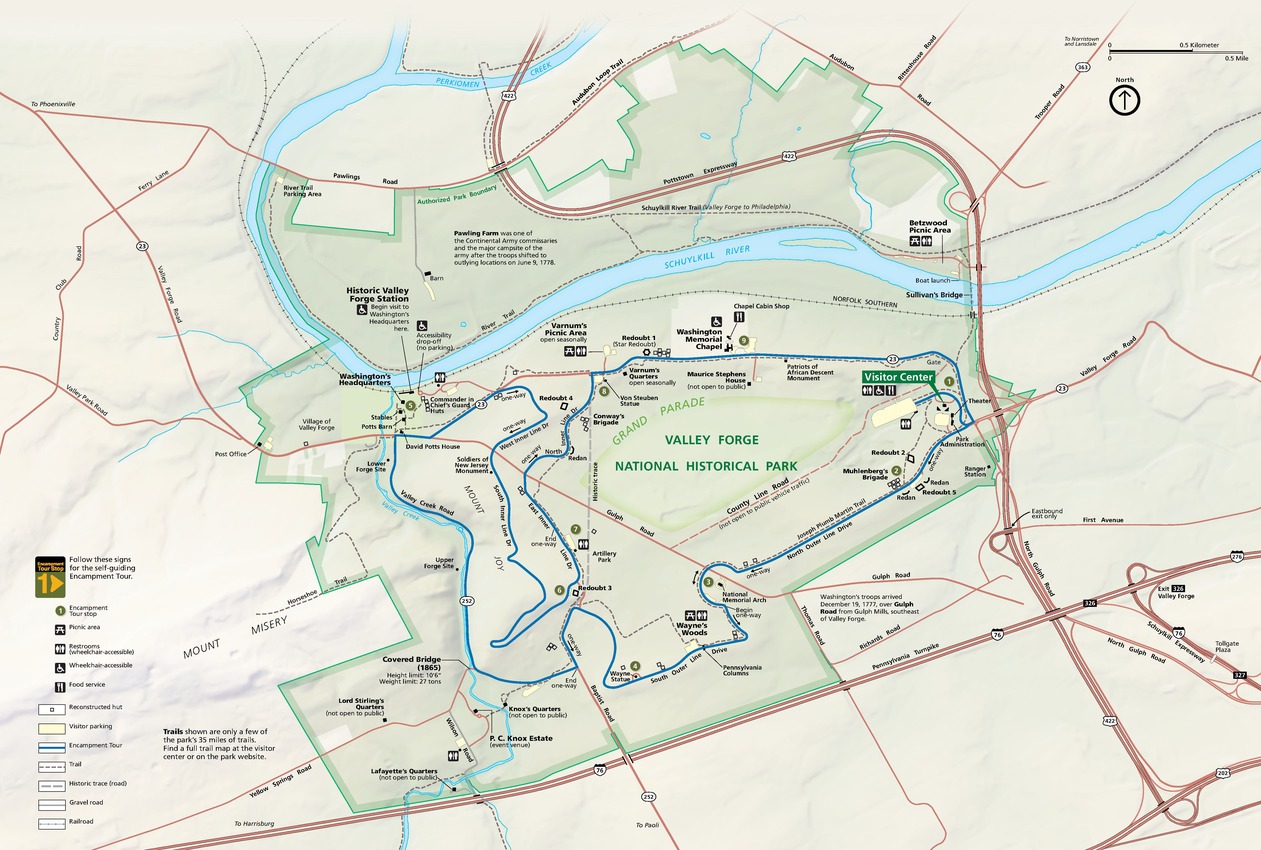 Map of Valley Forge National Historical Park in Pennsylvania. The park is highlighted in light green, squarish at the bottom and round and rough around the top, like a head of broccoli. The surrounding land is pale green with major roads noted in clay pink, the cyan blue Schuylkill River hooks across the top and through the park.