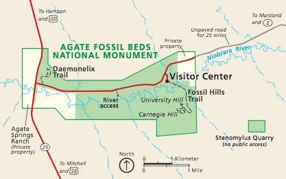 Map of Agate Fossil Beds National Monument in Nebraska. Shown in green against a tan background, the park is long, running from east to west. The Niobrara River ripples across the length of the park, which is accessible via a park road that branches off State Route 29.