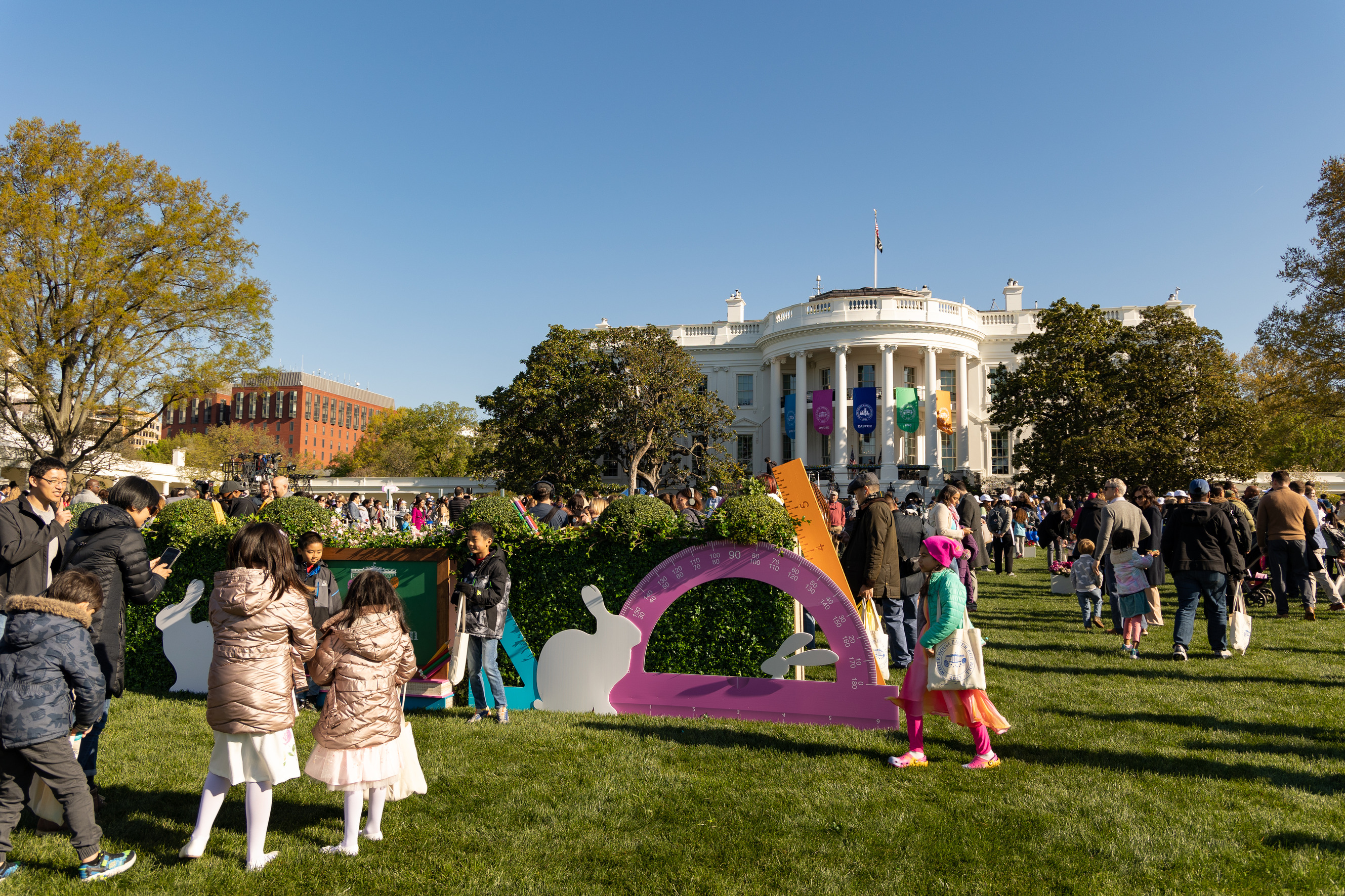 Visitors search for colorful easter eggs in front of the white house