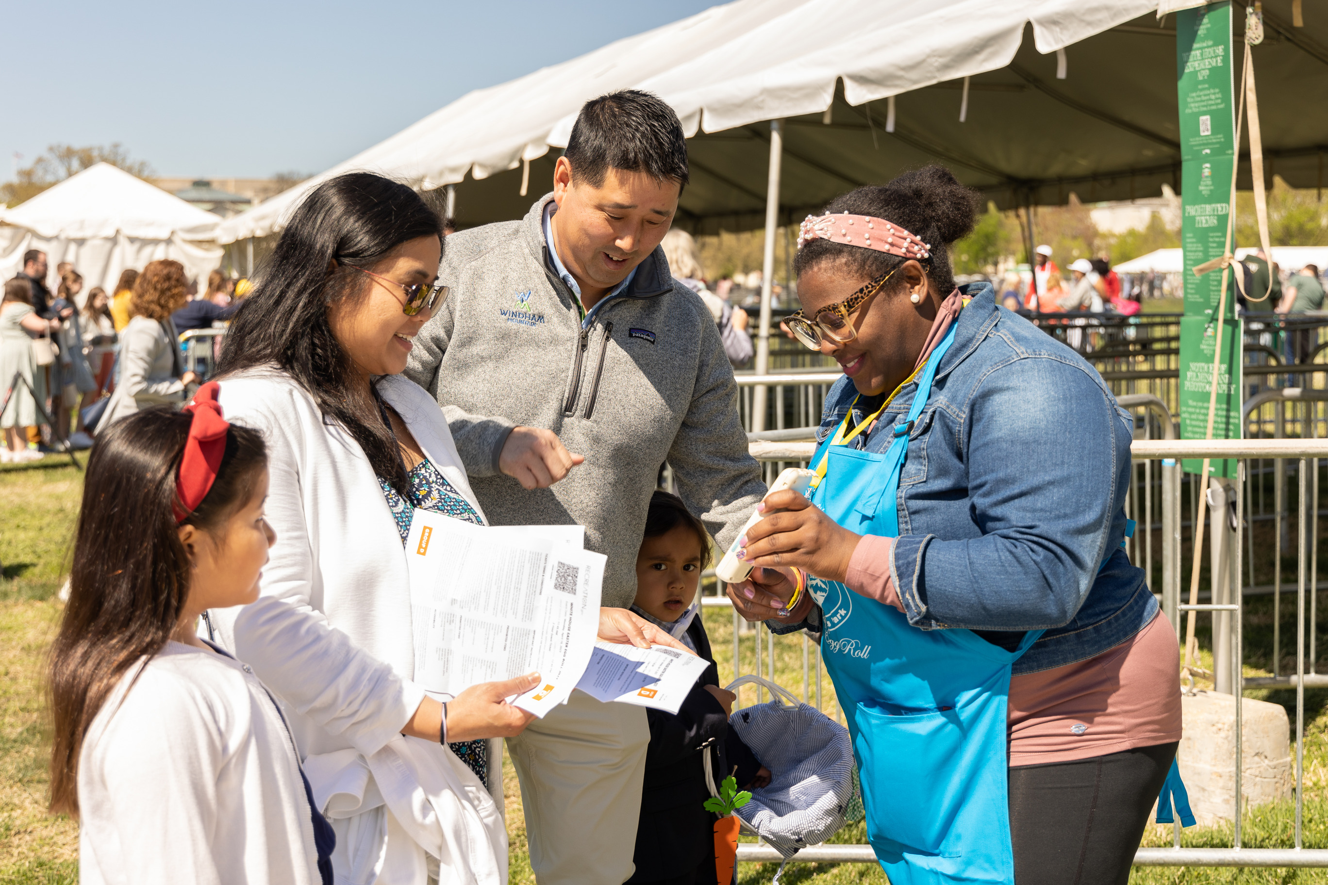 A volunteer scans visitors tickets at an event