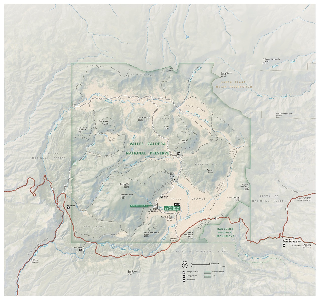 Map of Valles Caldera National Preserve in New Mexico. The park is mostly square with chunks taken out of the northeast and southeast corners. The boundaries are highlighted with green edges on pale sage-green lands with geological detailing. Major roads are noted in soft red.