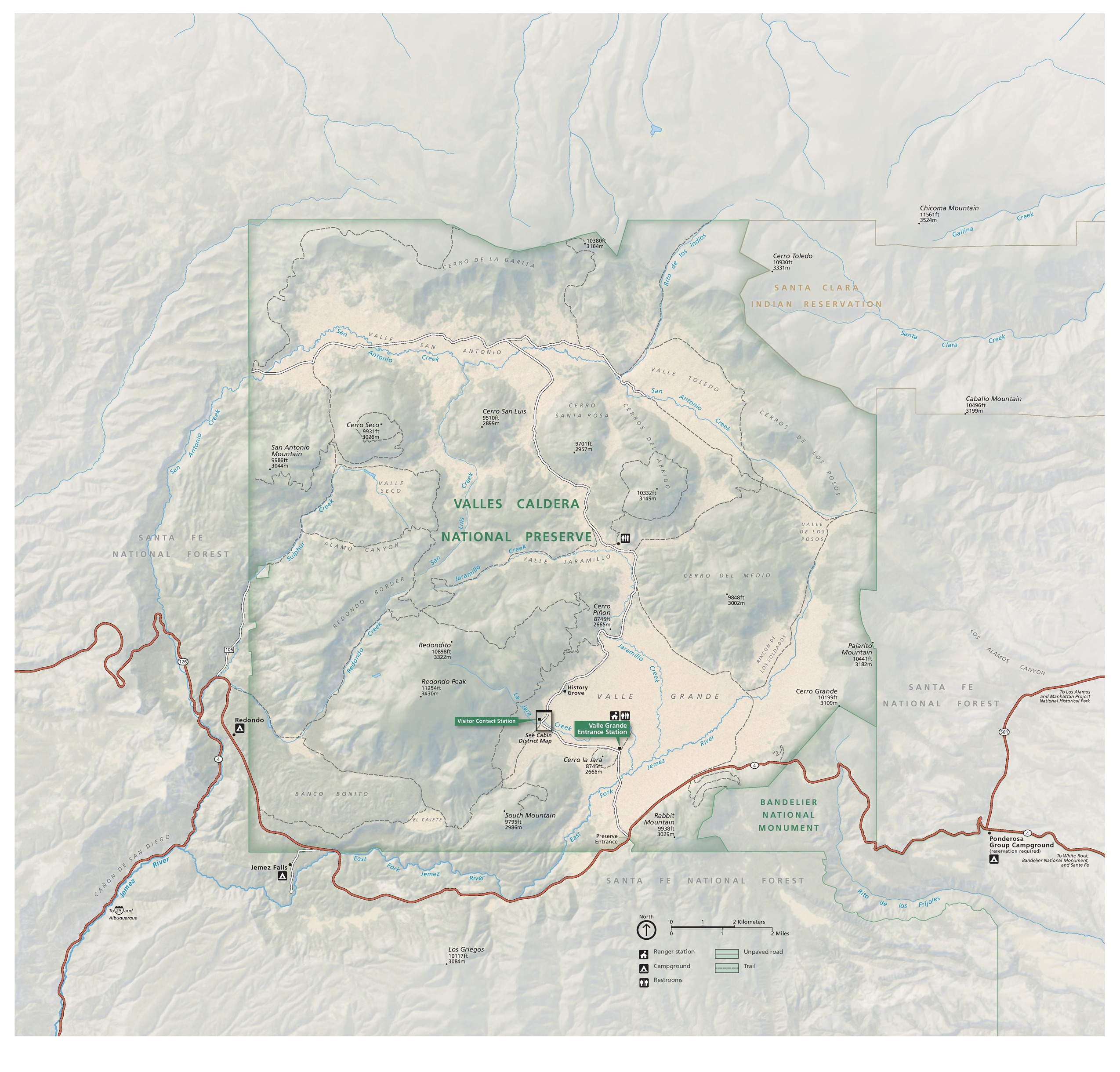 Map of Valles Caldera National Preserve in New Mexico. The park is mostly square with chunks taken out of the northeast and southeast corners. The boundaries are highlighted with green edges on pale sage-green lands with geological detailing. Major roads are noted in soft red.