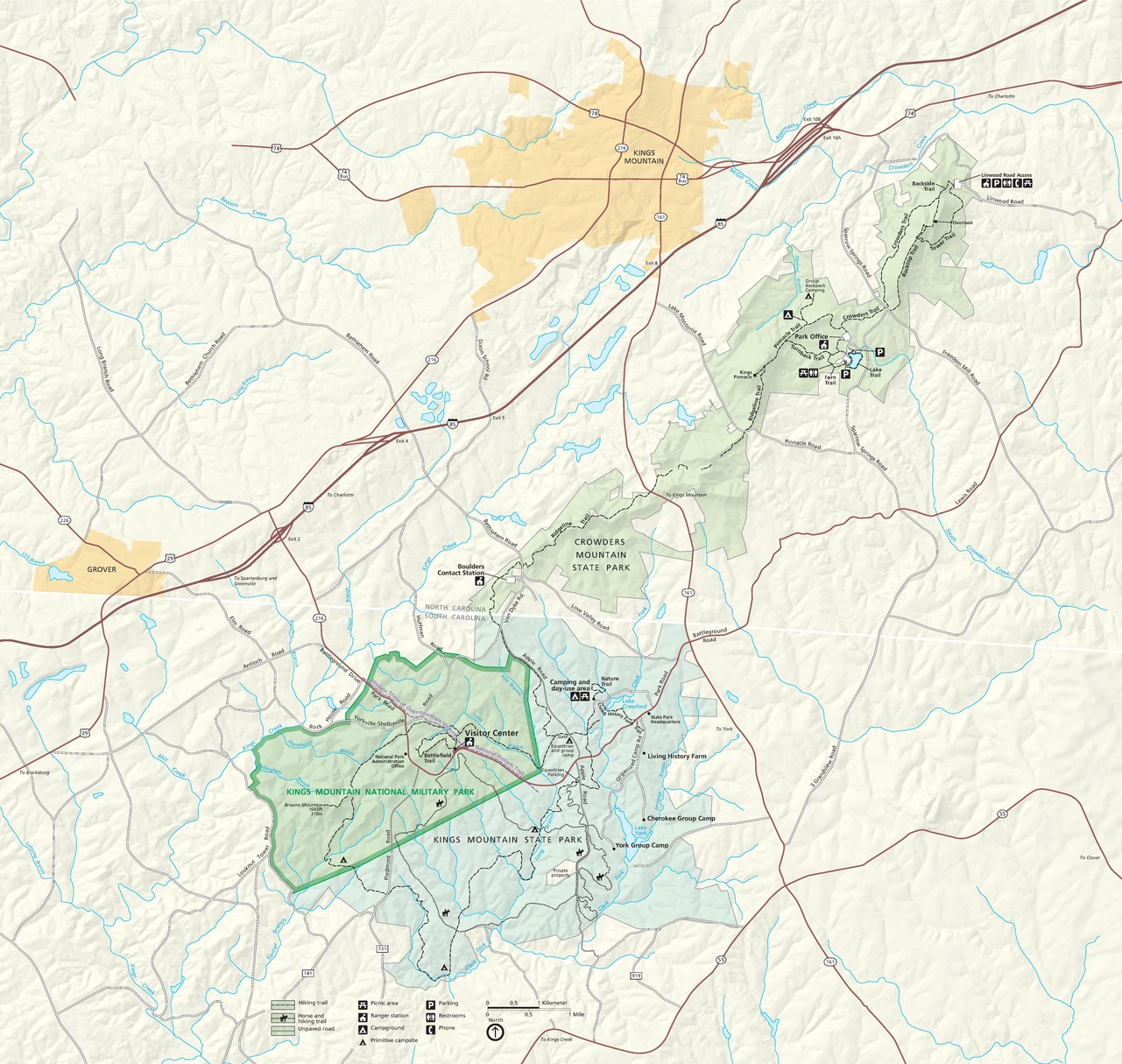 Map of Kings Mountain National Military Park in South Carolina. The park is highlighted in green and surrounding terrain is other shades of green, yellow, or beige. Roads and highways are represented in red or white encased with black lines.