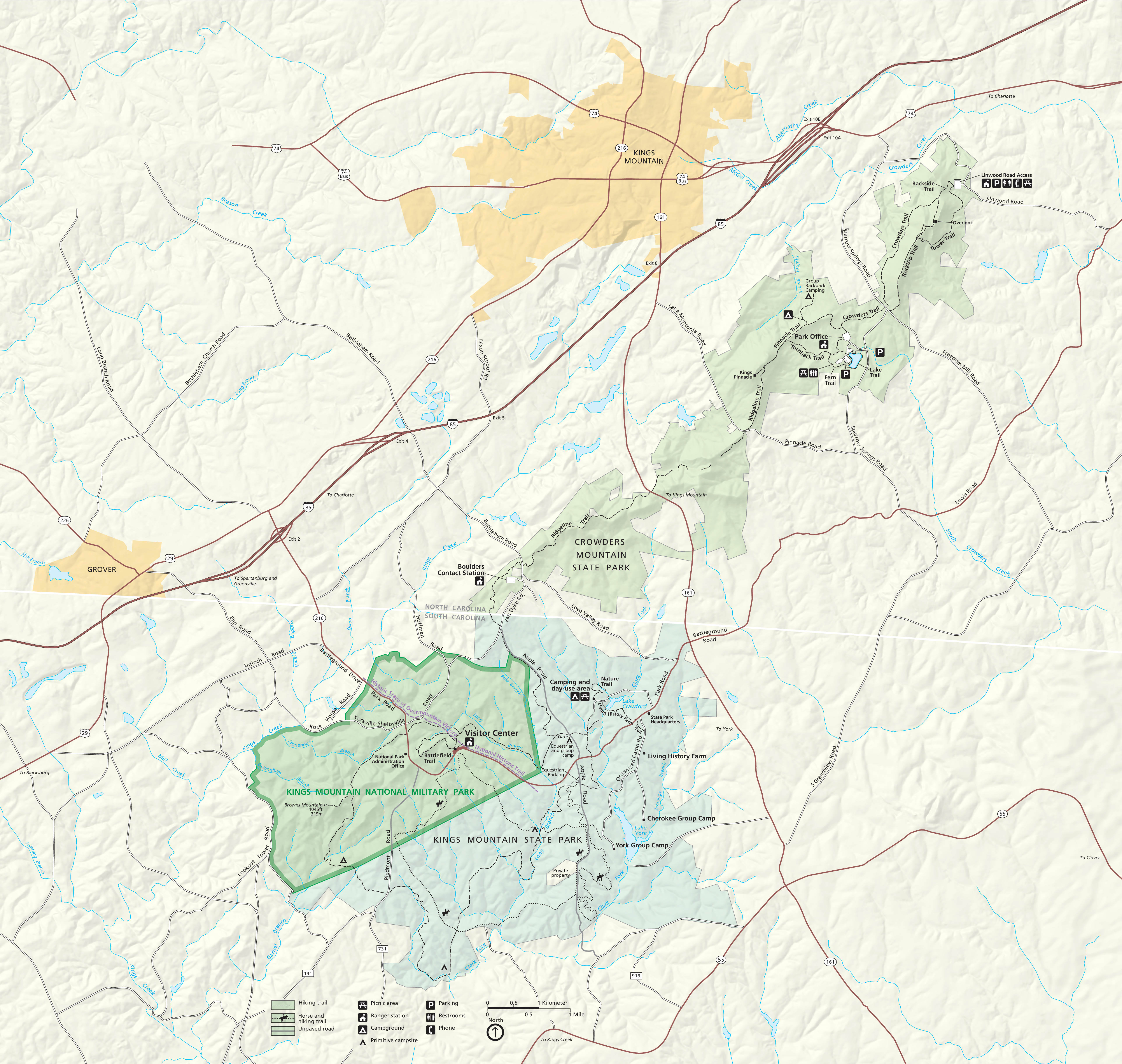 Map of Kings Mountain National Military Park in South Carolina. The park is highlighted in green and surrounding terrain is other shades of green, yellow, or beige. Roads and highways are represented in red or white encased with black lines.