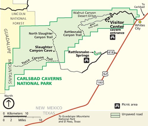 Map of Carlsbad Caverns National Park in New Mexico. The park is represented as an oblong green shape, stretching across in the west-to-east direction that tapers toward the top, with staircase-like staggered boundaries. A chunk of land shaded yellow that runs down most of the left edge from the top corner is labeled Lincoln National Forest. The Guadalupe Mountains run down the western edge of the map through both the national park and national forest.