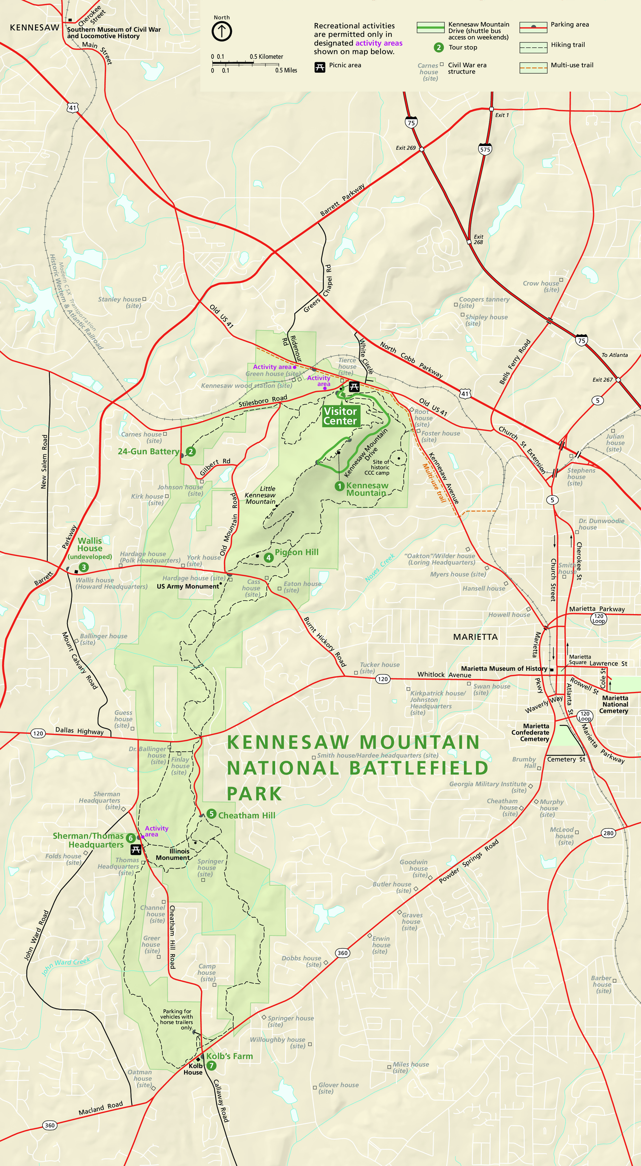 Map of Kennesaw Mountain National Battlefield Park in Georgia. The map is tan with the tall, narrow park is highlighted in green. Major highways are represented by red lines and park trails by dashed black lines.