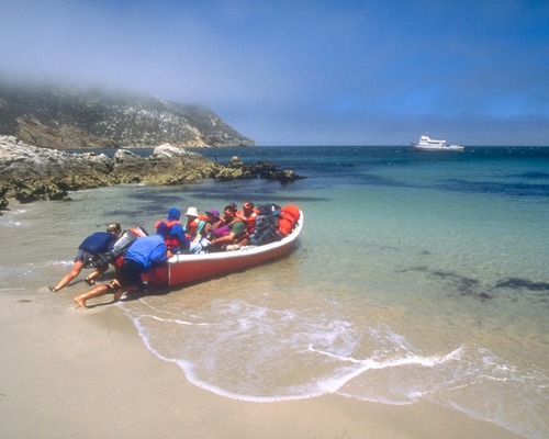 Visitors land by skiff along the two mile stretch of white sand beach within Cuyler Harbor.