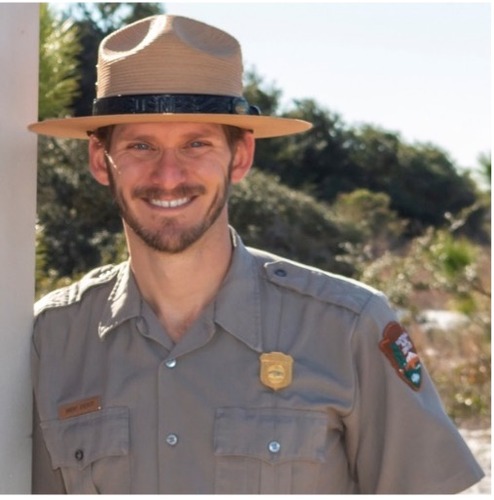 White man in a park ranger uniform.