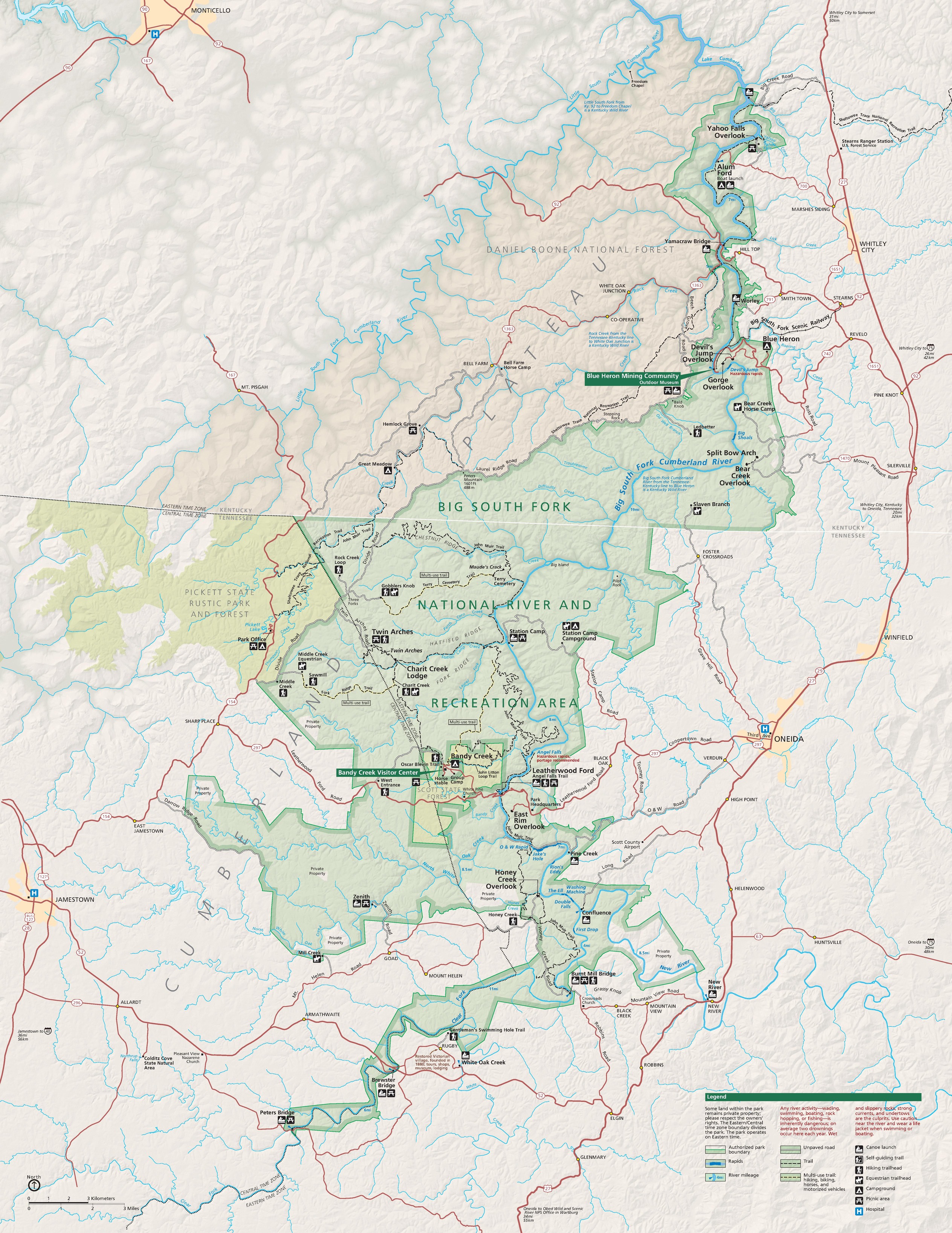 Map of Big South Fork National River and Recreation Area in Kentucky and Tennessee. The park area is shown as a green, rippling shape connected to a state park, which is smaller and shown in darker green. A national forest, shown in beige, stretches across the northern border of the park.