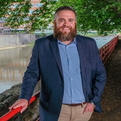 White man standing in front of a waterway.