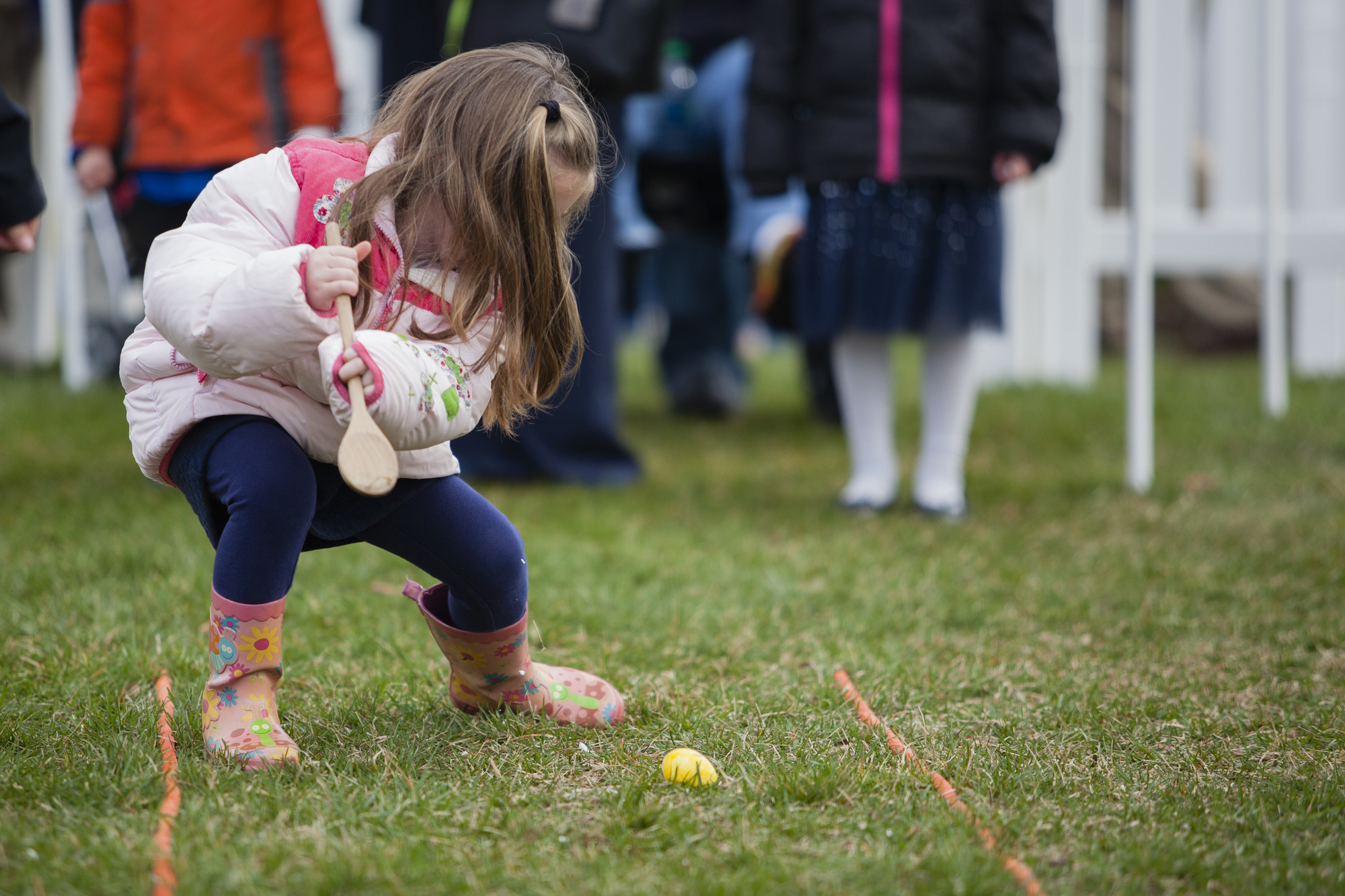 A young child participates in the Egg Roll. 