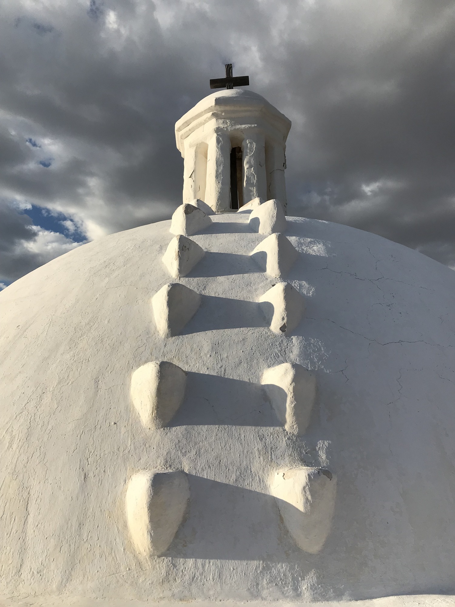 dome detail with stormy sky, flakes of plaster and cracks showing