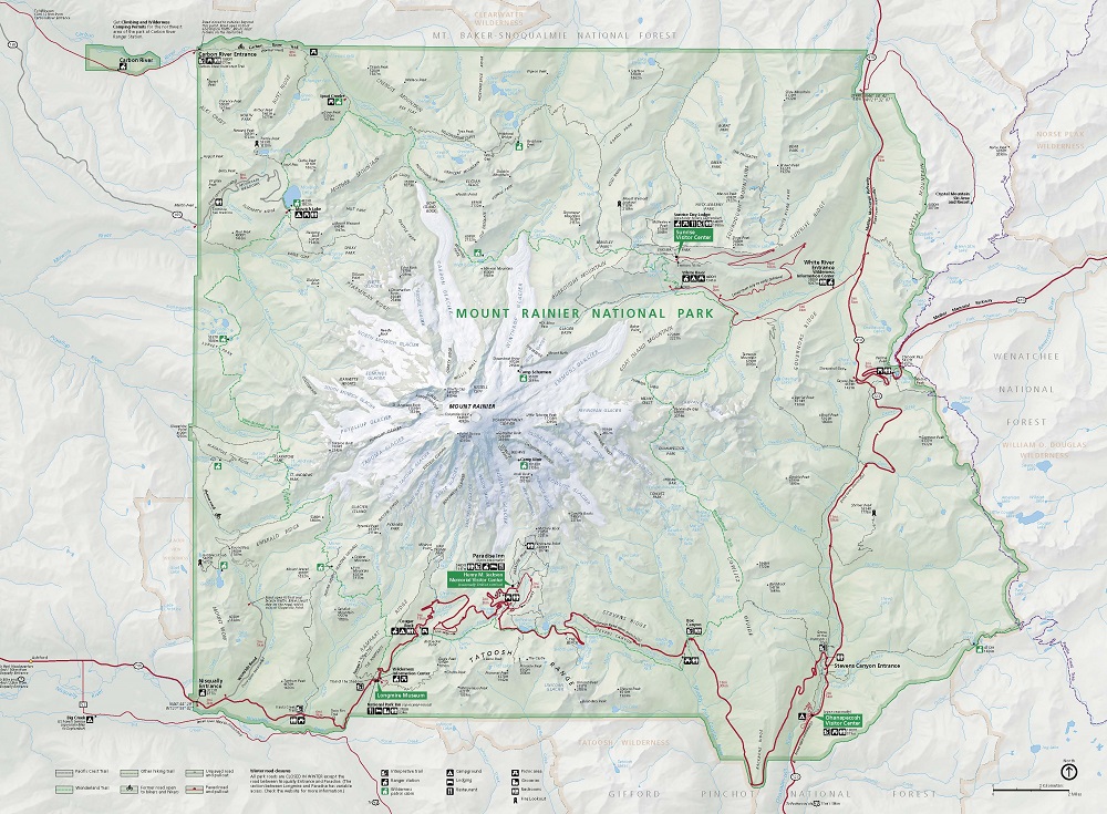 Map of Mount Rainier National Park in Washington. The park’s shape is roughly square and is shaded in green, while the surrounding area is colored beige. At the center, Mount Rainier is surrounded by twenty-four glaciers, which are shown in white. The glaciers create a starburst shape around Mount Rainier.
