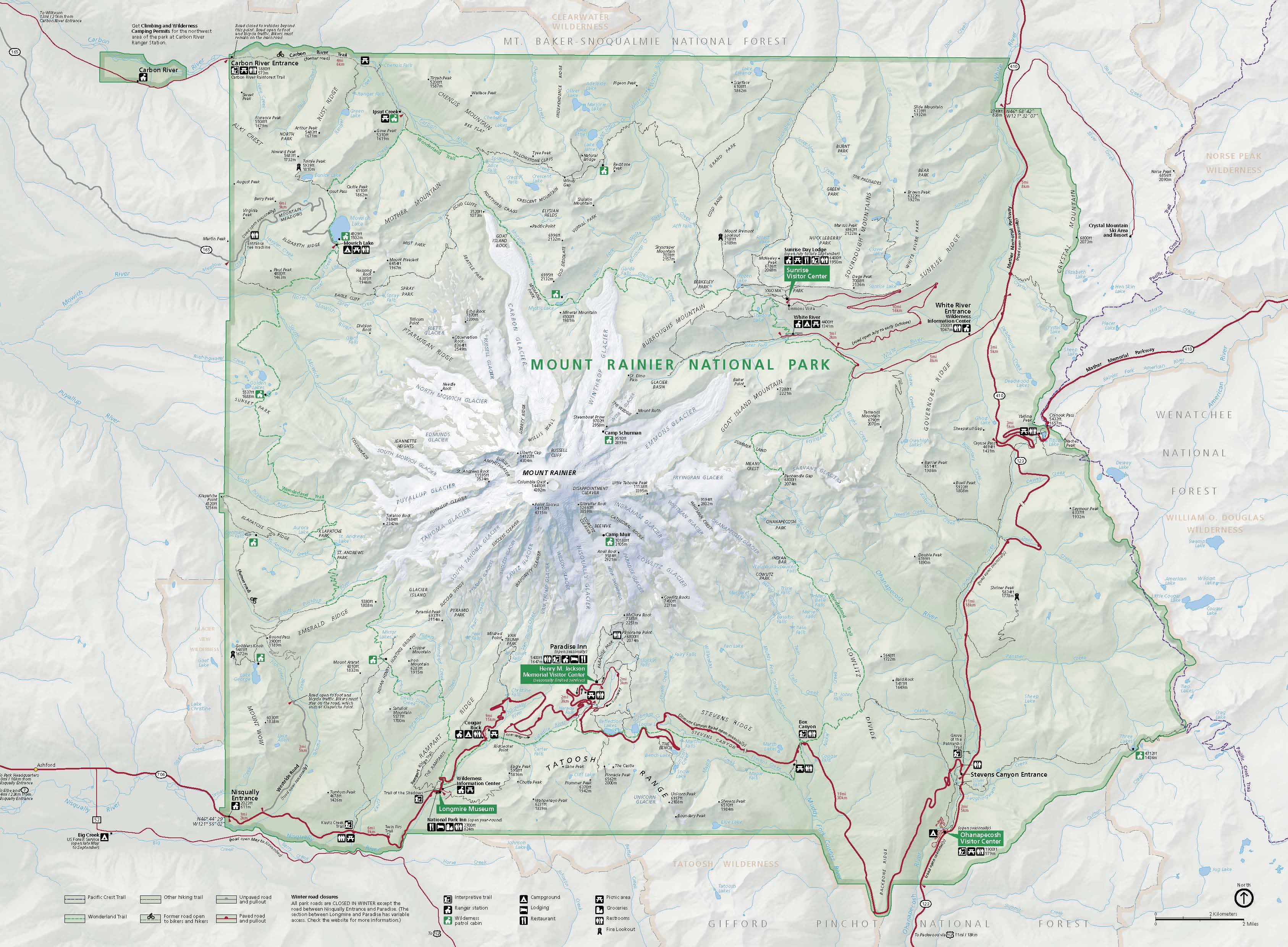 Map of Mount Rainier National Park in Washington. The park’s shape is roughly square and is shaded in green, while the surrounding area is colored beige. At the center, Mount Rainier is surrounded by twenty-four glaciers, which are shown in white. The glaciers create a starburst shape around Mount Rainier.