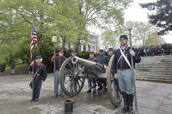Re-enactors pose with a Civil War-era cannon