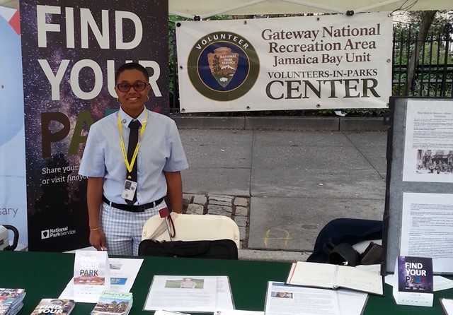 Kahmia Moise, Centennial Volunteer Ambassador at Gateway National Recreation Area, staffs a booth at PrideFest.