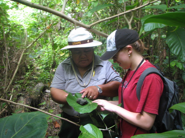Archaeologists examining stone.