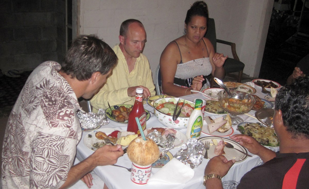 Visitors enjoying a meal with a Home Stay family.
