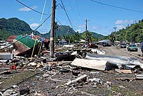 A boat lies amidst the rubble in downtown Pago Pago