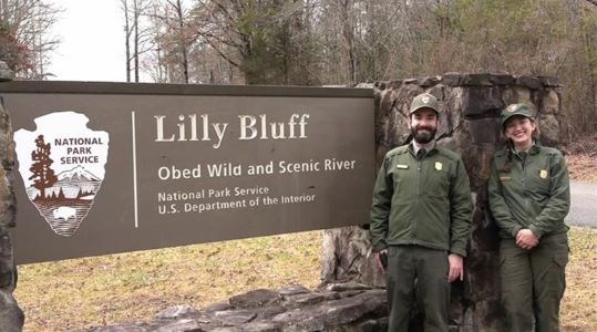 Ranger Nicole and Ranger Ian standing in front of the Lilly Bluff entrance sign.