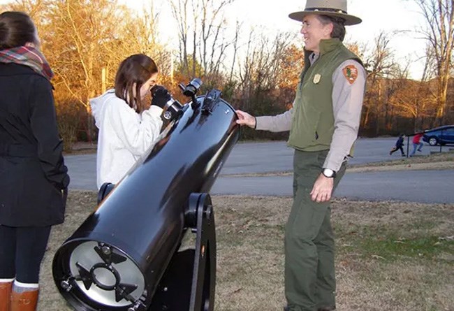 Park ranger with telescope