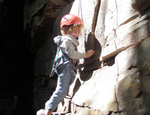 Little girl climbing with help
