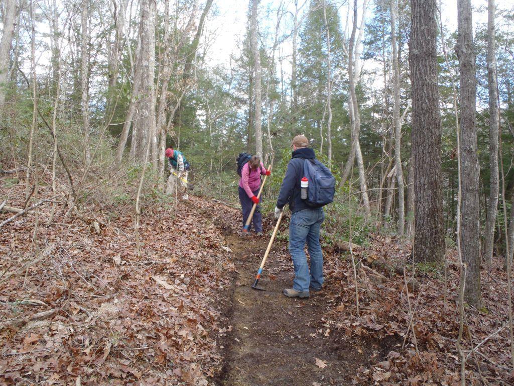 volunteers walking along trail
