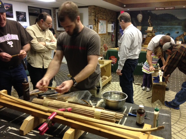 people working on a man made bow