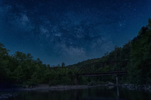 Milky Way galaxy visible above Nemo Bridge under a dark, starry sky.