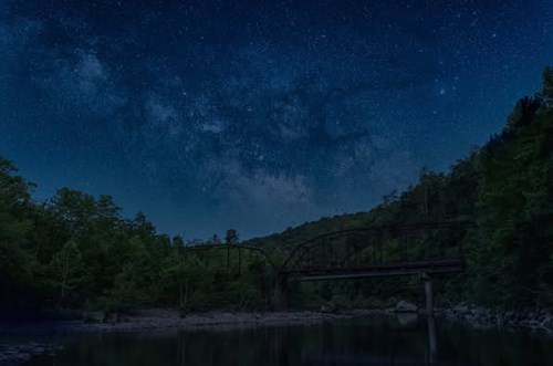 Milky Way galaxy visible above Nemo Bridge under a dark, starry sky.