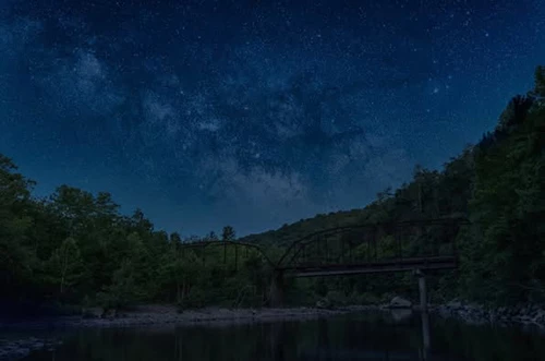 Magnificent Milky Way Over Nemo Bridge Milky Way galaxy visible above Nemo Bridge under a dark, starry sky.