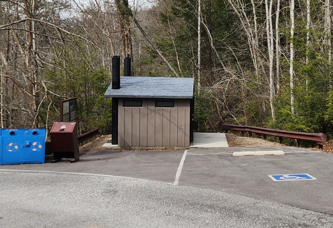 Vault toilet building and accessible parking.