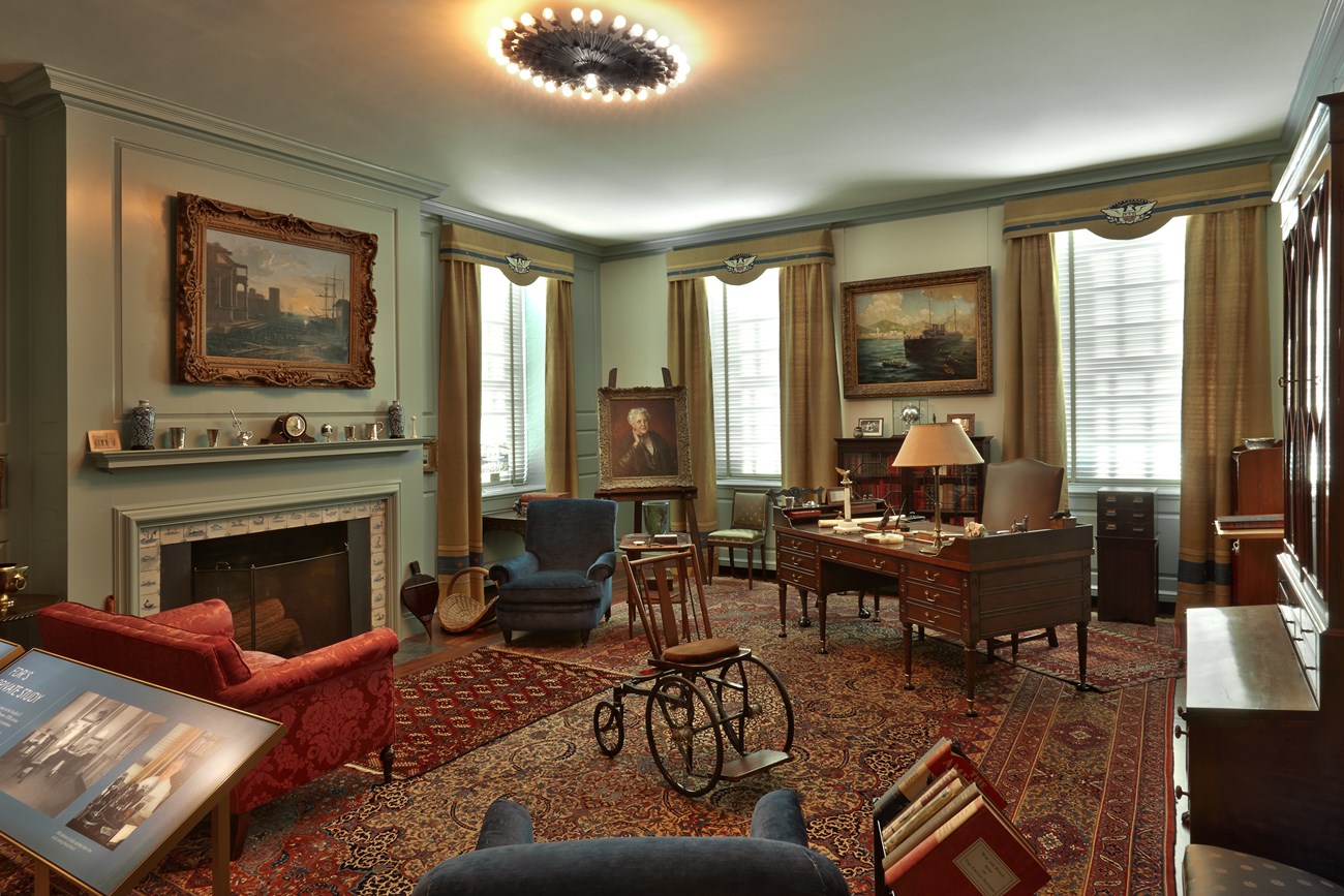 FDR's Study A room with a desk, bookcases, family portraits, and artworks.