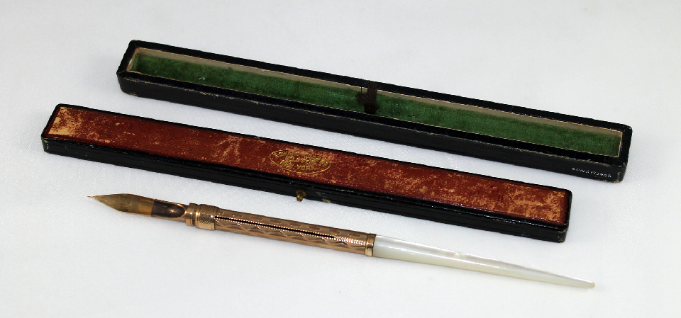 A gold and mother-pearl pen manufactured by Edward Todd & Company of New York.